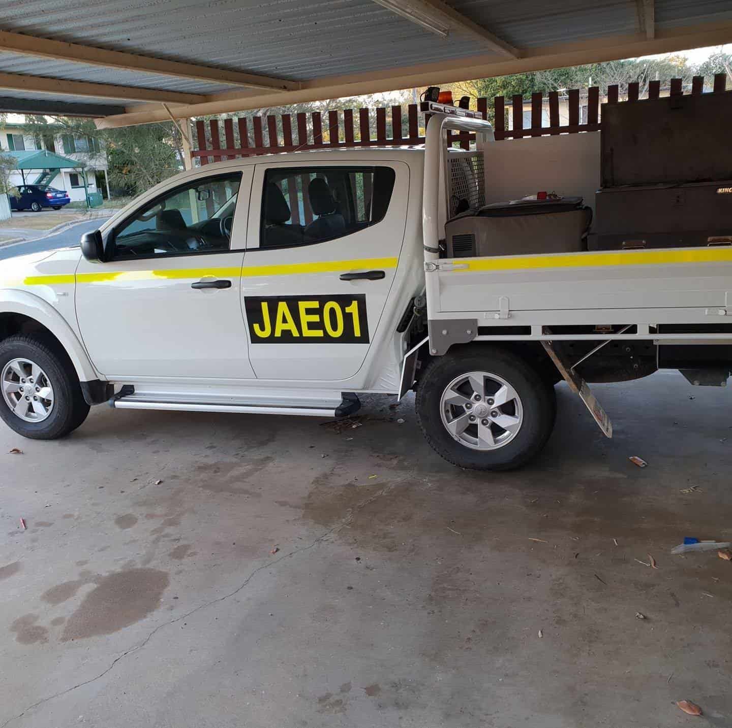 A White Truck With a Yellow License Plate That Says Jae01 — Jacko's Auto & Marine Electrics In Mackay Harbour, QLD