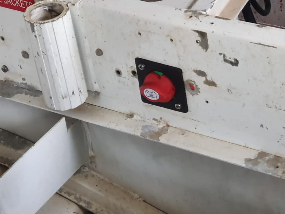 A Red Button With a Green Light on It is on a White Surface — Jacko's Auto & Marine Electrics In Mackay Harbour, QLD