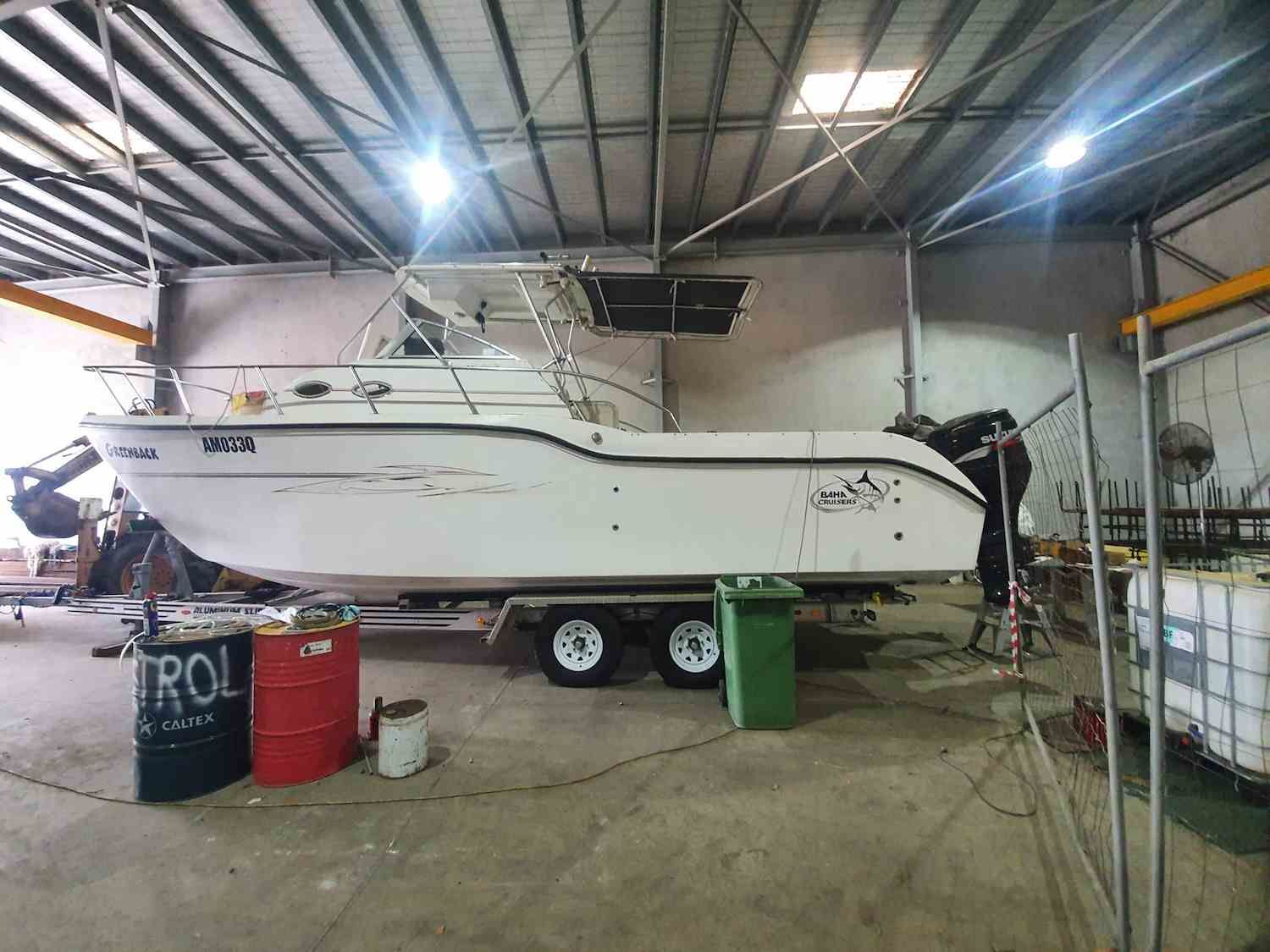 A Boat is Sitting on a Trailer in a Warehouse — Jacko's Auto & Marine Electrics In Mackay Harbour, QLD