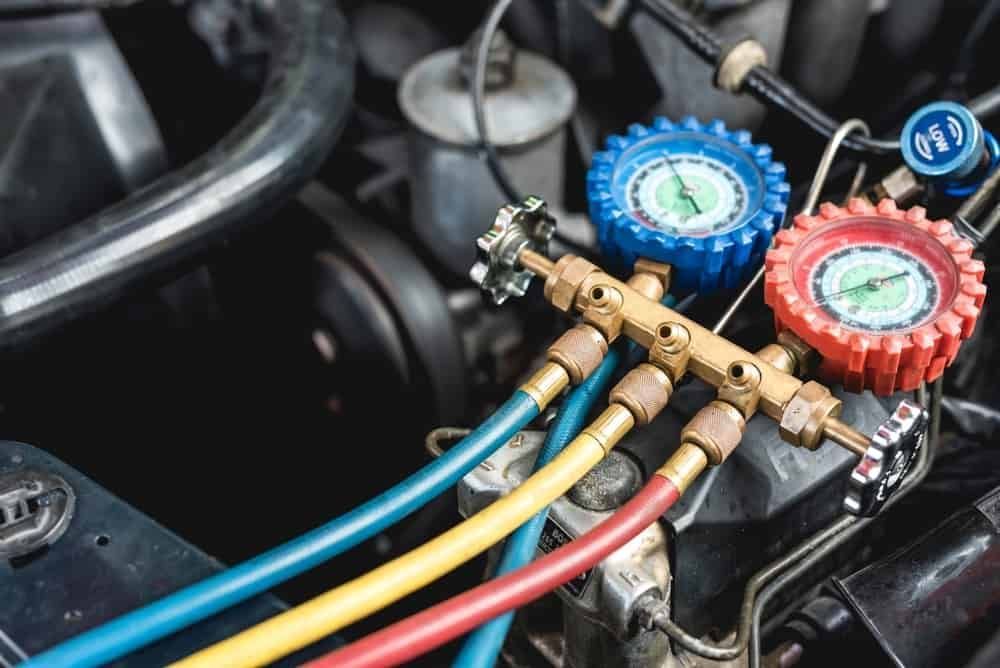 A Close Up of a Car Engine With Hose and Gauges — Jacko's Auto & Marine Electrics In Mackay Harbour, QLD