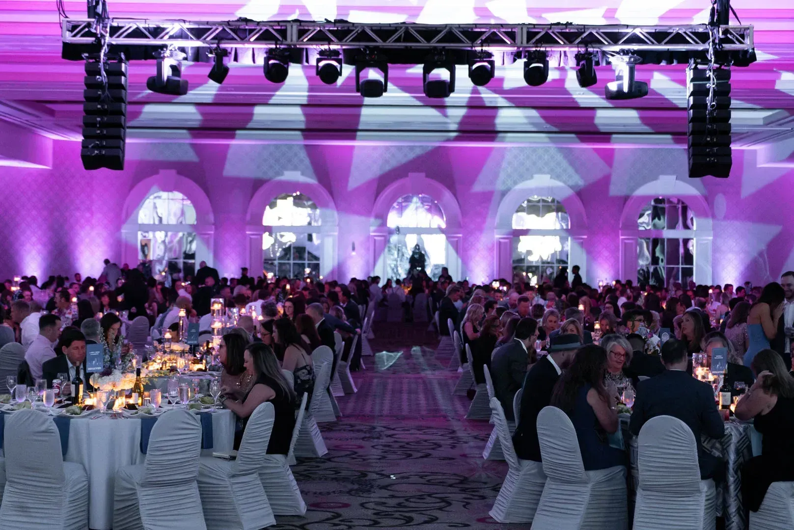 A large room filled with people sitting at tables and chairs