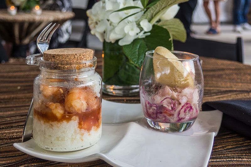 Two jars of food are sitting on a white plate on a table.