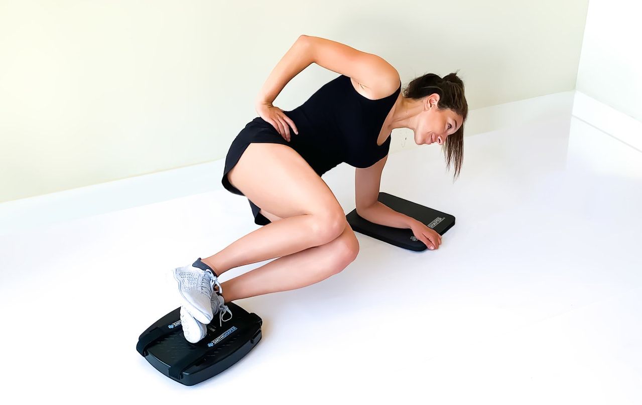Shows a woman performing Sideways Jackknives exercise for oblique and core muscles using the SmithShaper® PRO ASR for Abs, Core, Legs, Butt, Waist, Chest, Arms and Shoulders.