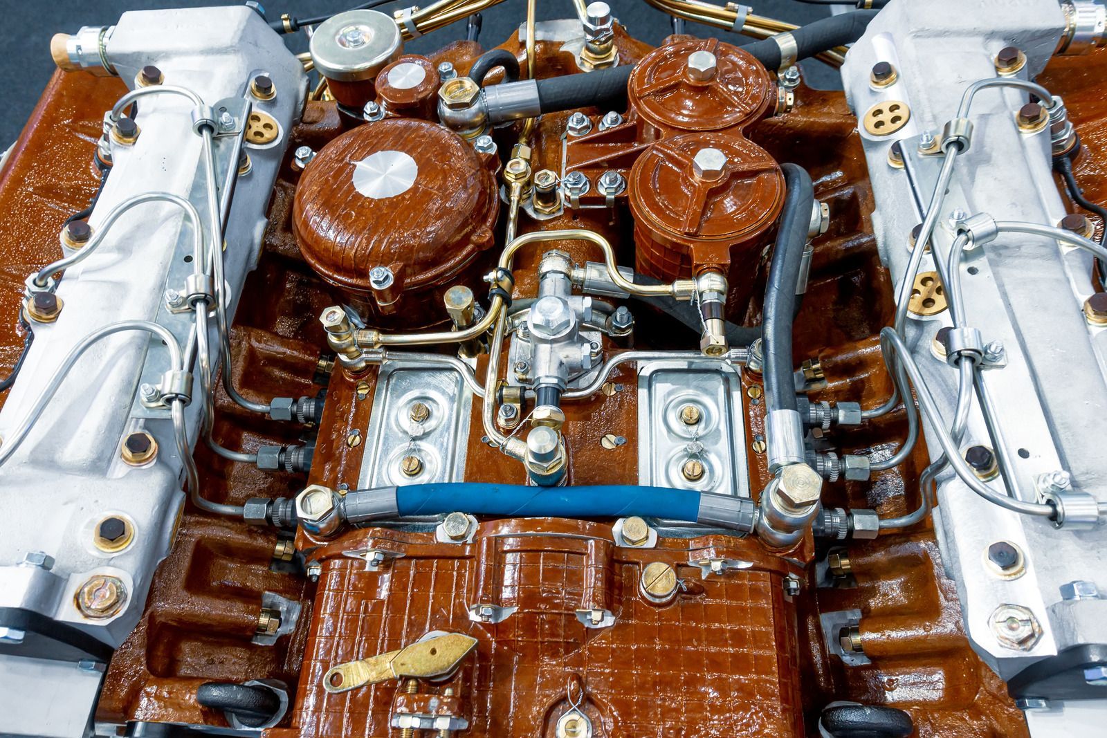 A shiny, silver turbocharger for an engine, showing the housing and a central turbine.
