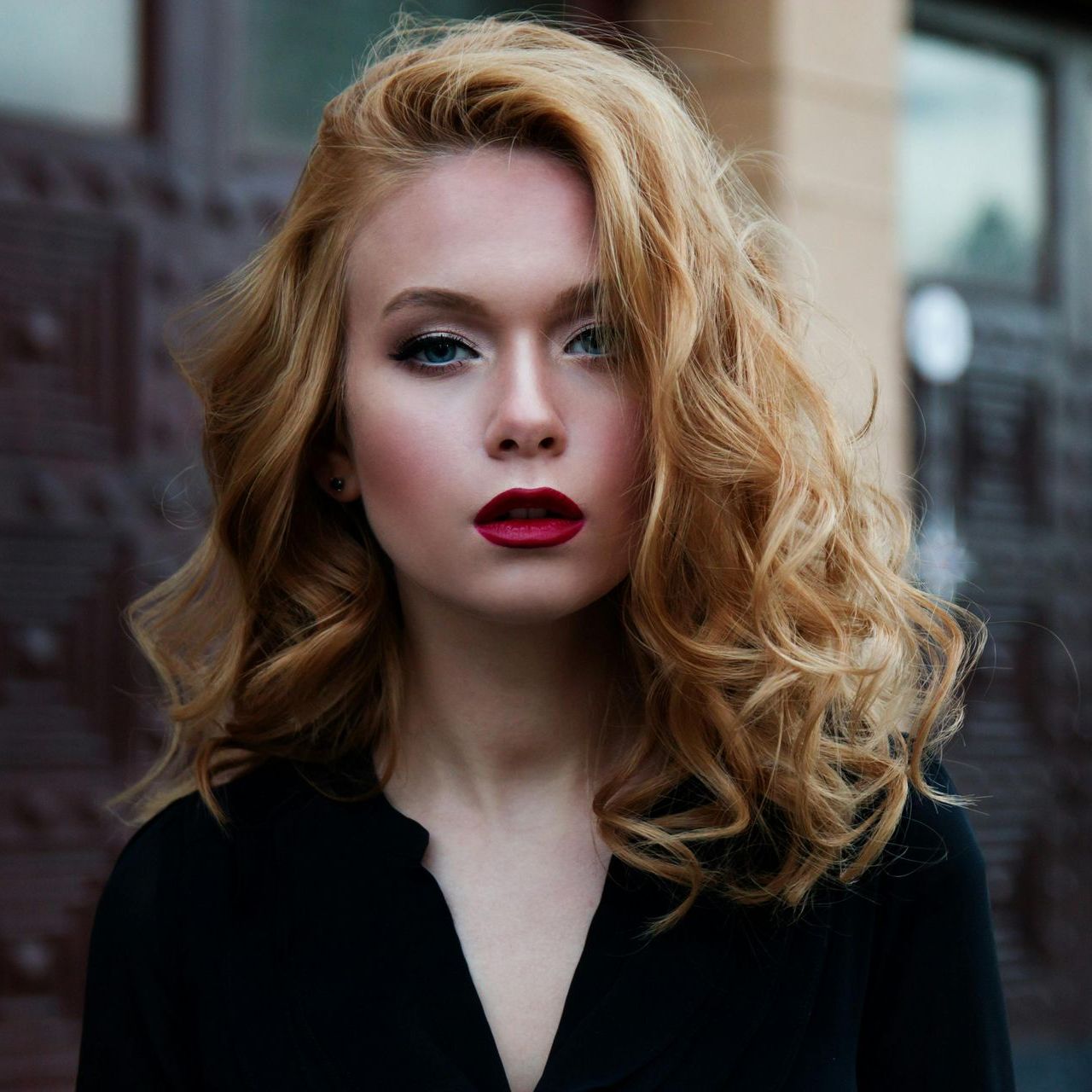 A woman with red lips is wearing a black shirt