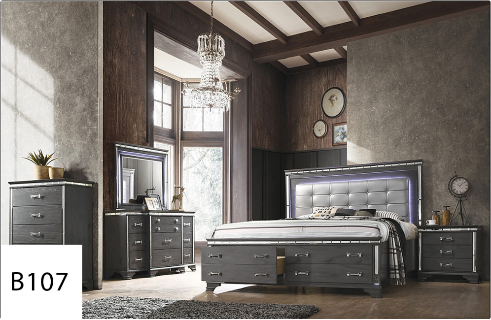 A bedroom with a bed , dresser , nightstand and mirror.