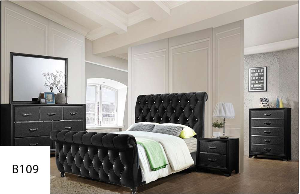 A bedroom with a bed , dresser , nightstand and mirror.