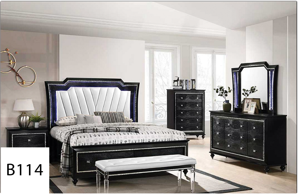 A bedroom with a bed , dresser , mirror , nightstand and bench.