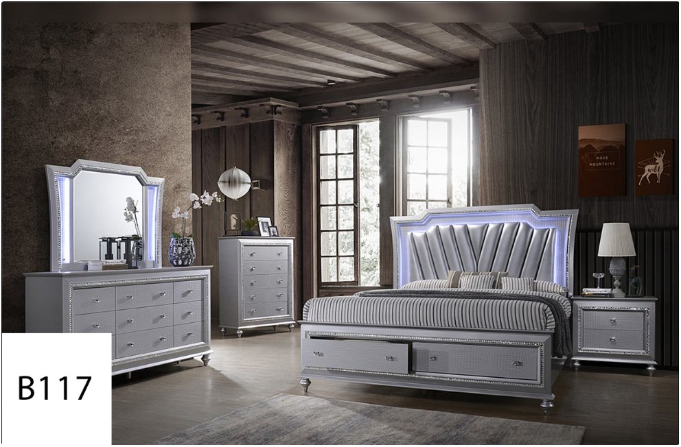 A bedroom with a bed , dresser , mirror and nightstand.