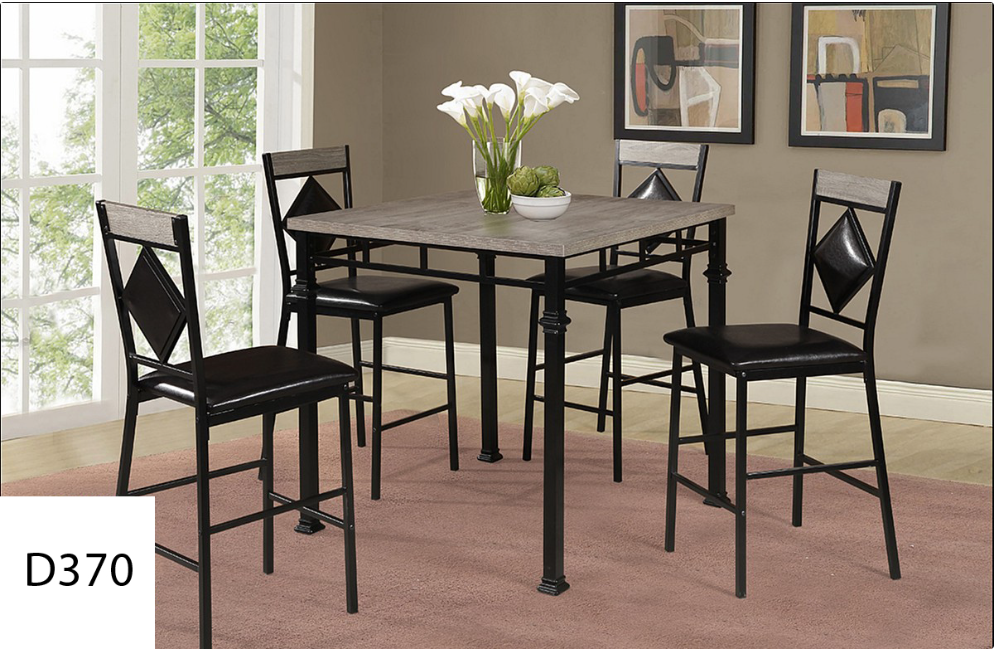 A dining room table with four chairs and a vase of flowers on it