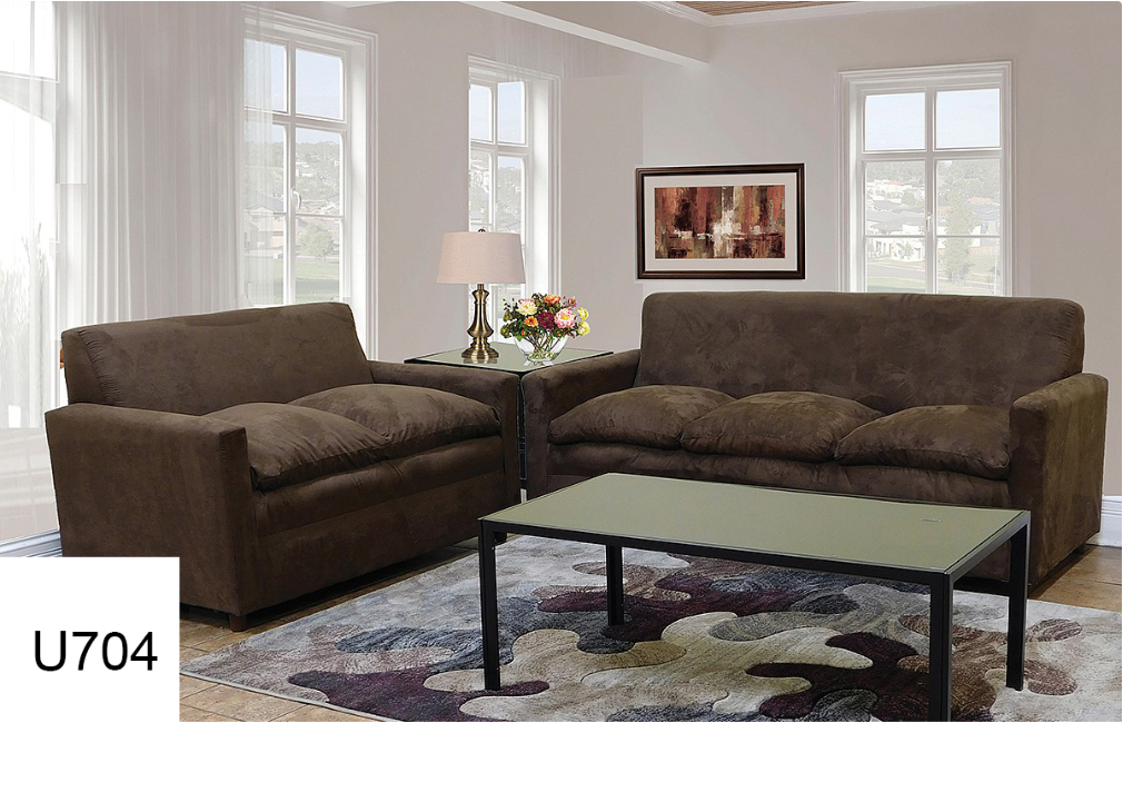 A living room with two brown couches and a coffee table