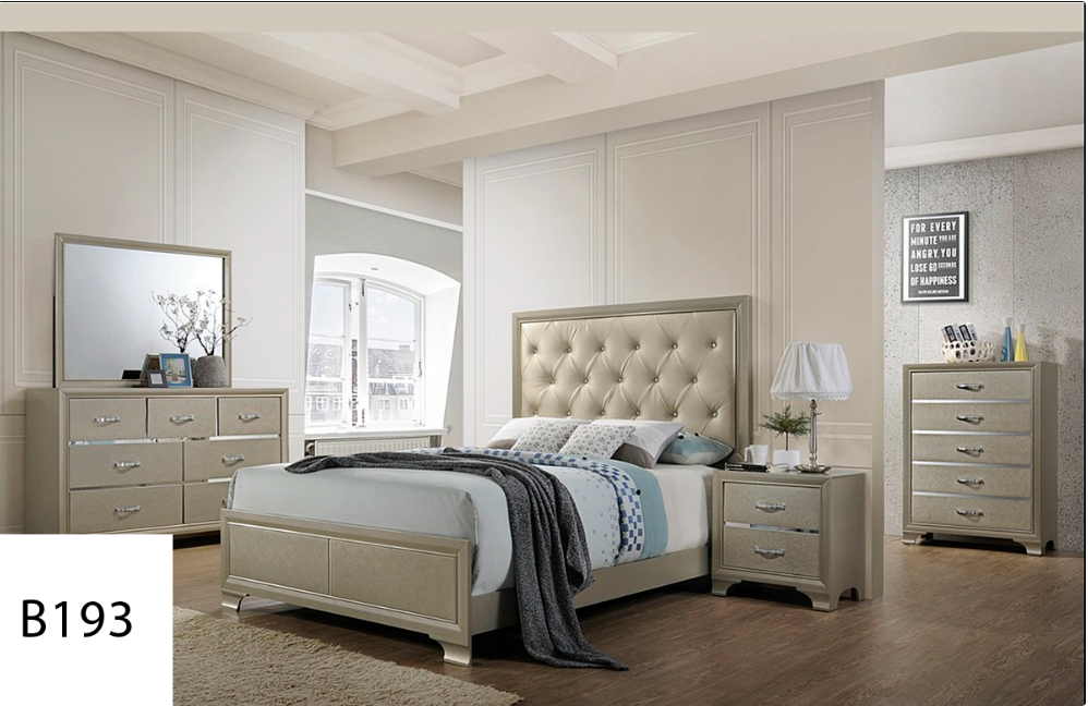 A bedroom with a bed , dresser , nightstand and mirror.