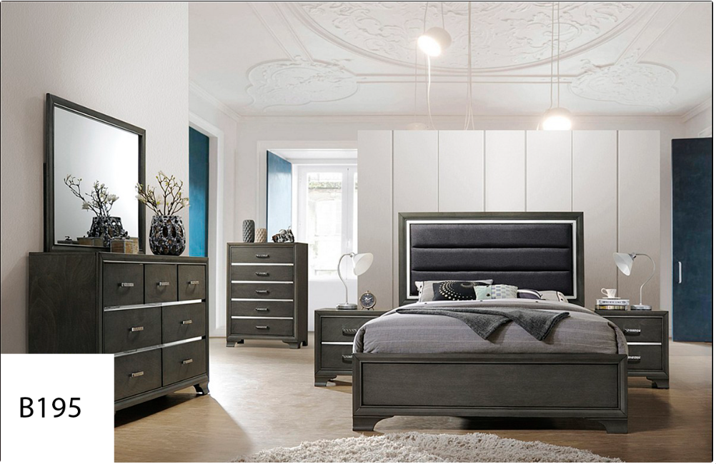 A bedroom with a bed , dresser , mirror and nightstand.