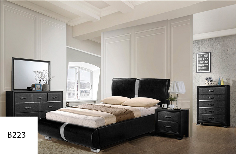 A bedroom with a bed , dresser , nightstand and mirror.