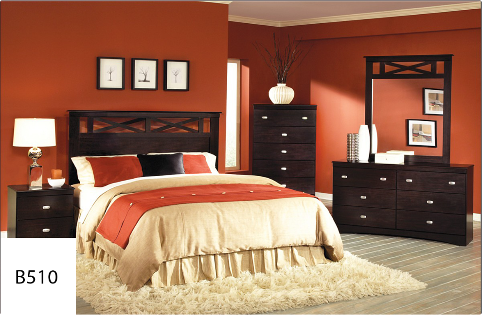 A bedroom with red walls and a bed and dresser