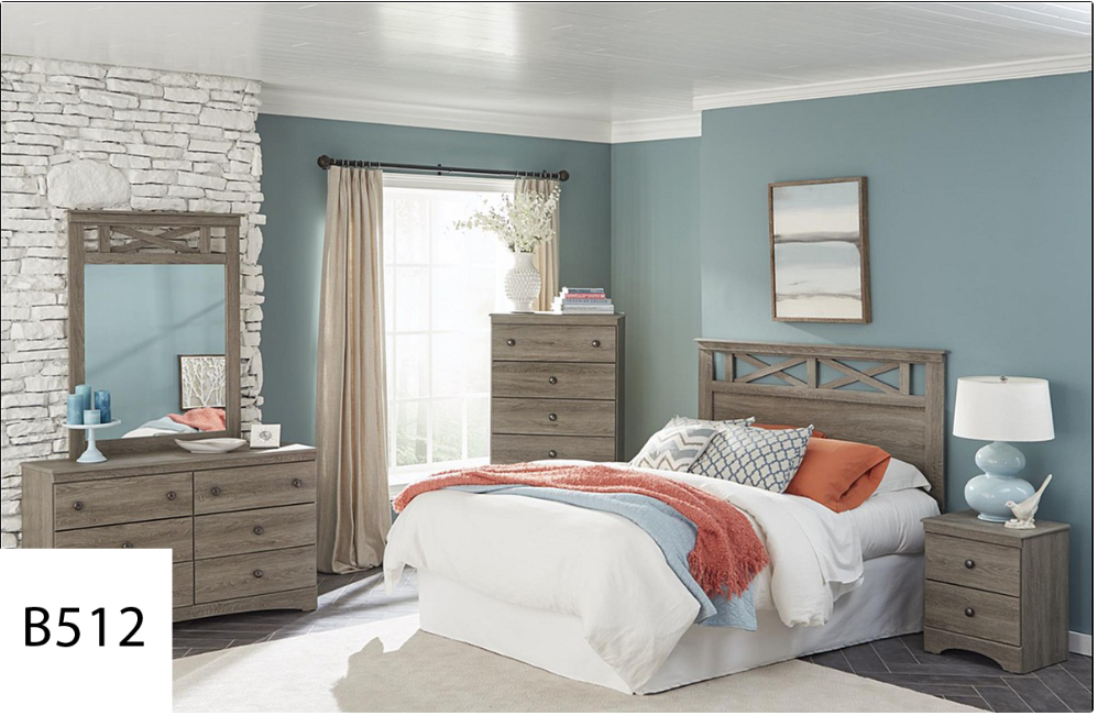 A bedroom with a bed , dresser , nightstand and mirror.