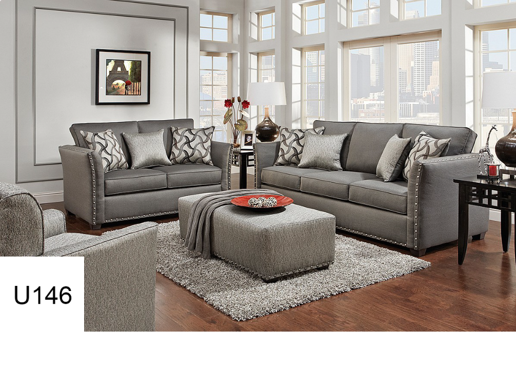 A living room with a gray couch and ottoman