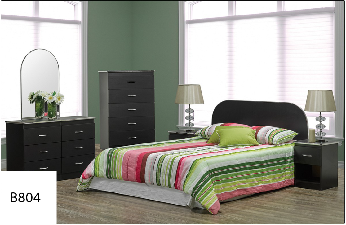 A bedroom with a bed dresser nightstand and mirror