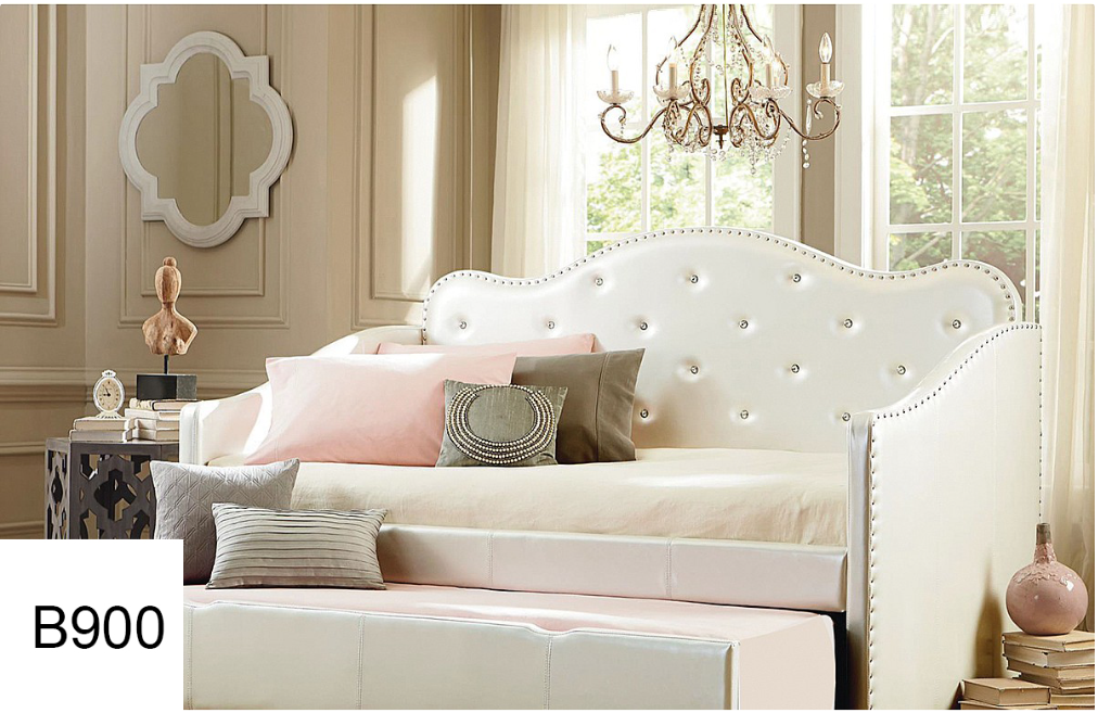 A white day bed is sitting in a room next to a window.