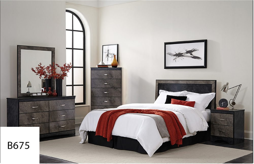 A bedroom with a bed , dresser , mirror and nightstand.