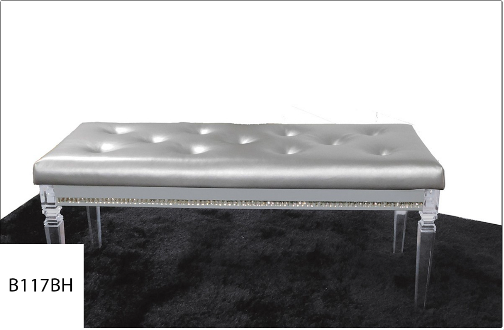A silver bench with clear legs sits on a black rug