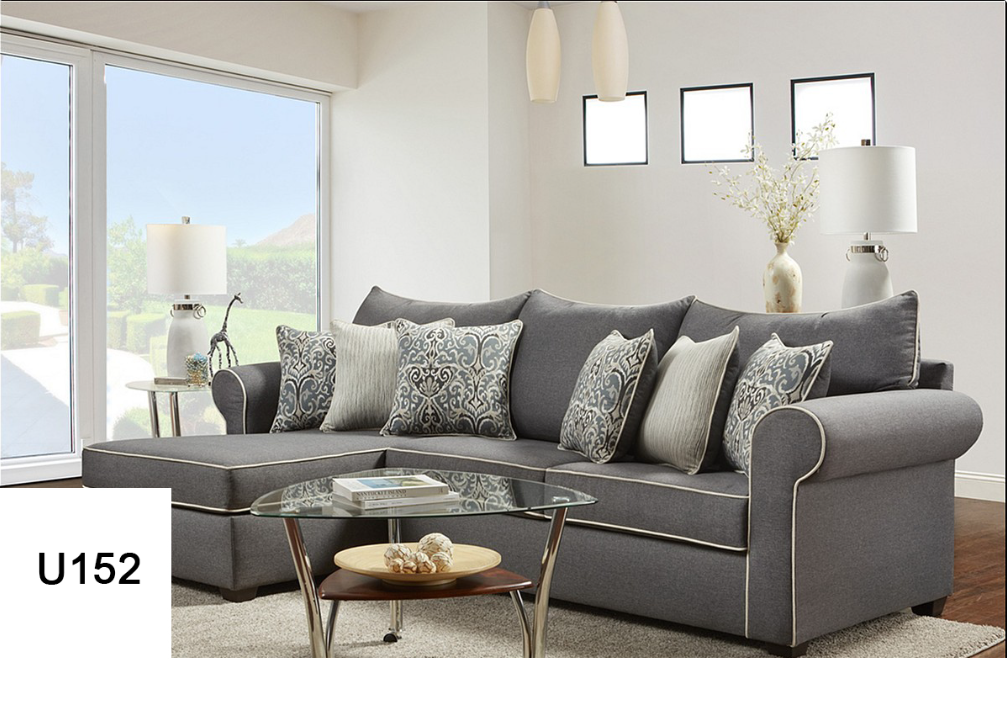 A living room with a gray sectional couch and a glass coffee table