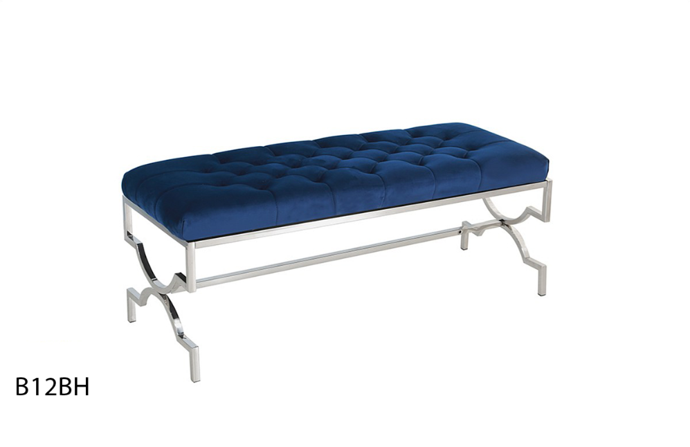 A blue velvet bench with a stainless steel frame on a white background.