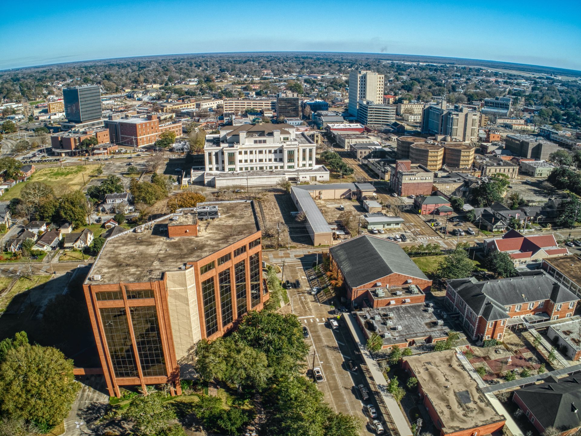 An aerial view of a city with lots of buildings and trees.