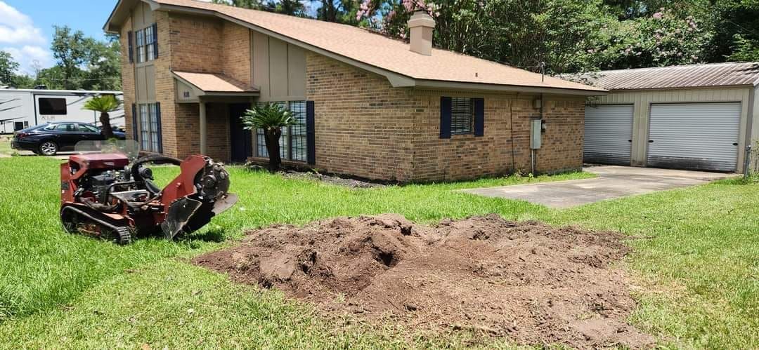 Wood chipper disposing of tree debris into the back of a high sided trailer after a successful tree removal in Beaumont, TX