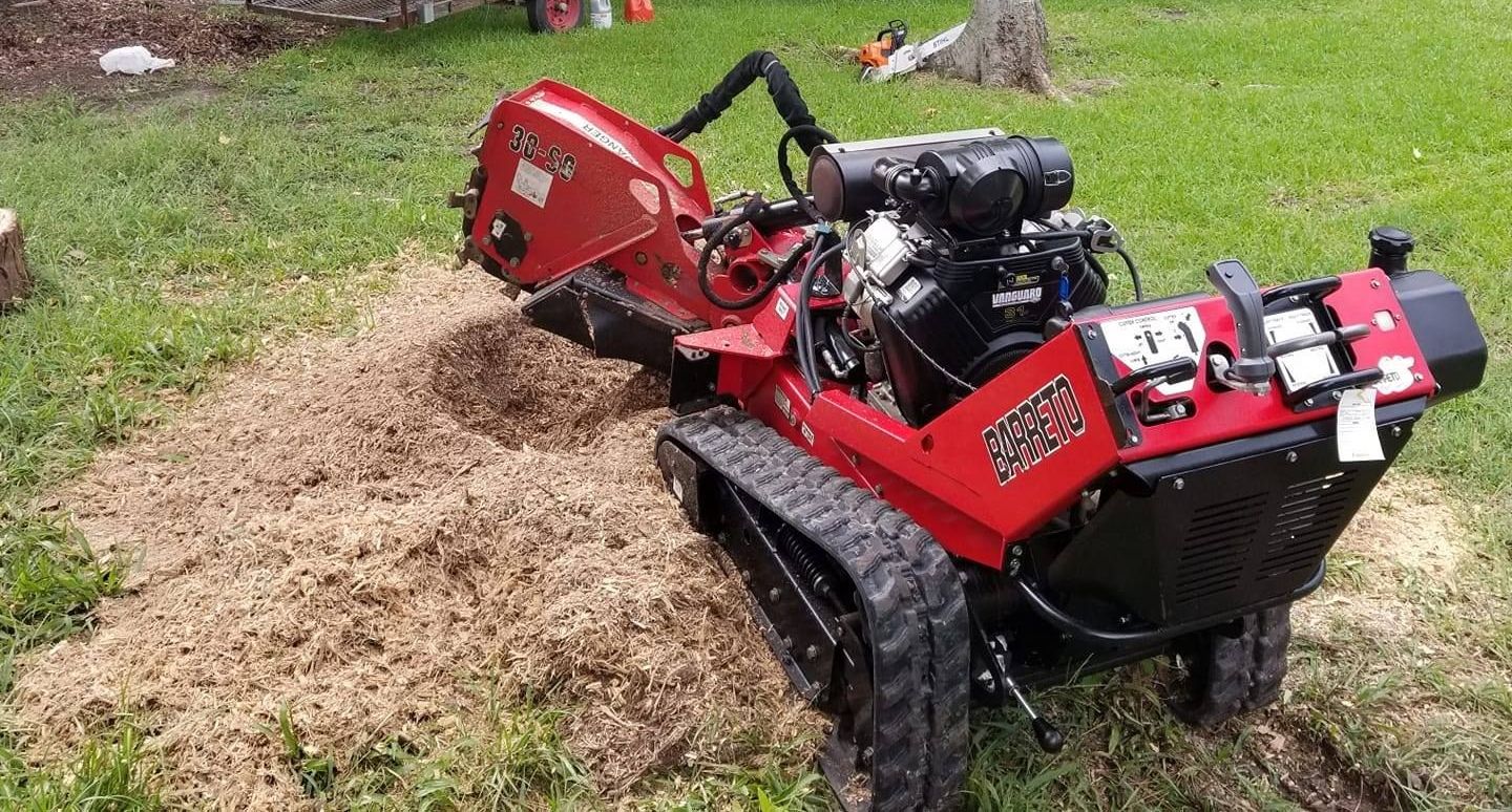 A tractor is parked in the backyard of a house.