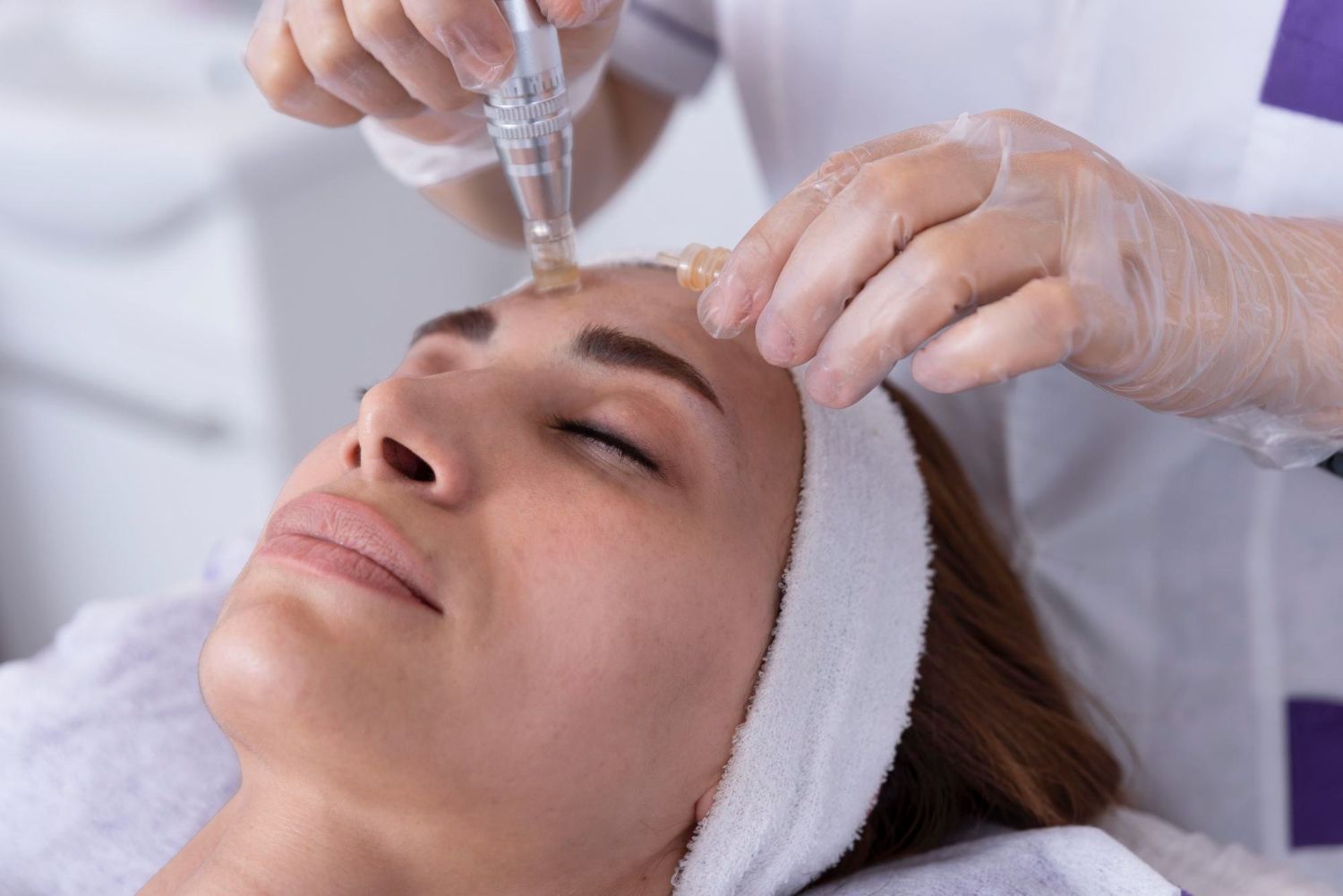 A woman is getting a facial treatment at a beauty salon.