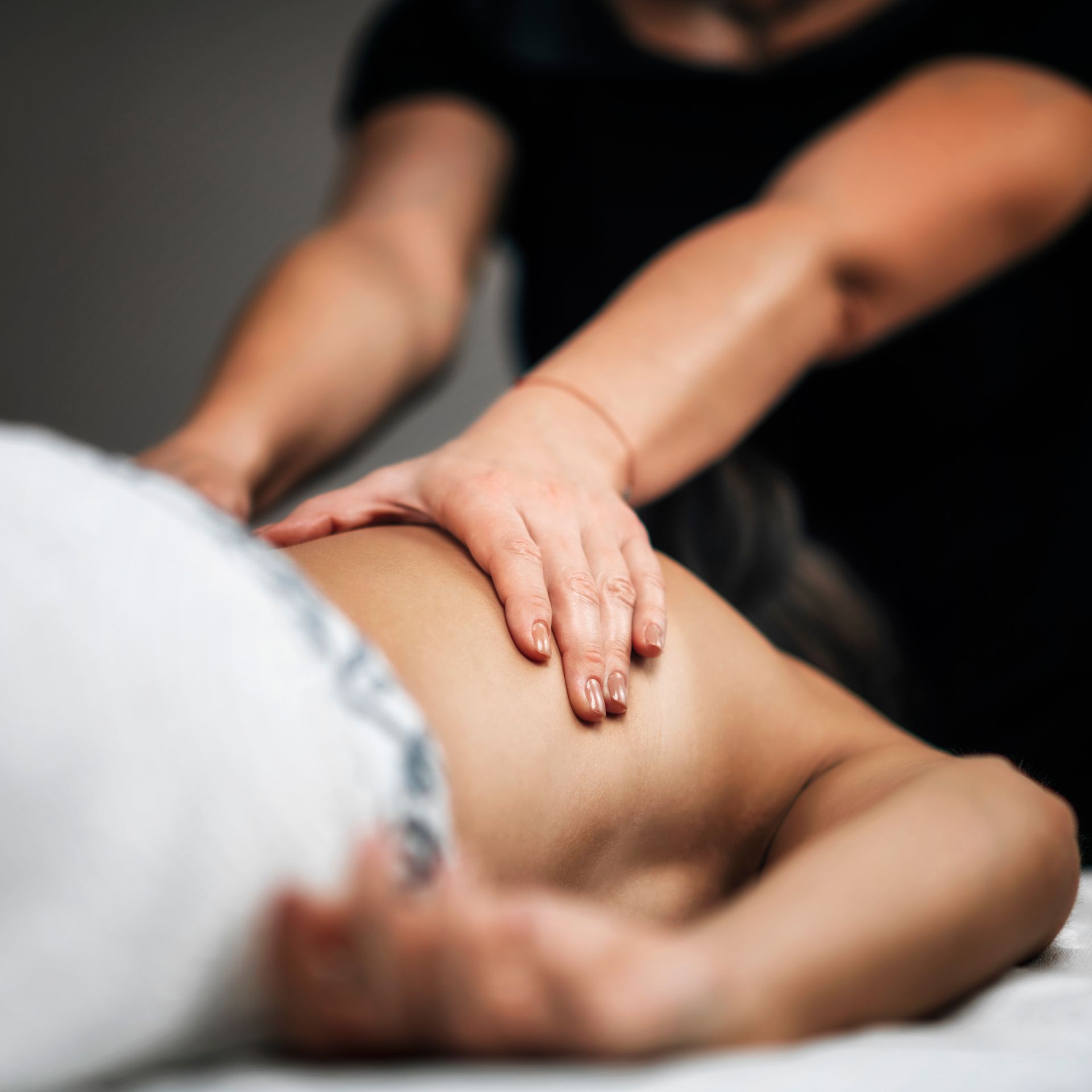 A woman is getting a massage on her back