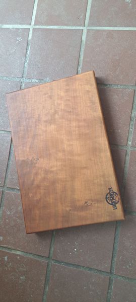 Wooden board with a design on a tiled surface.