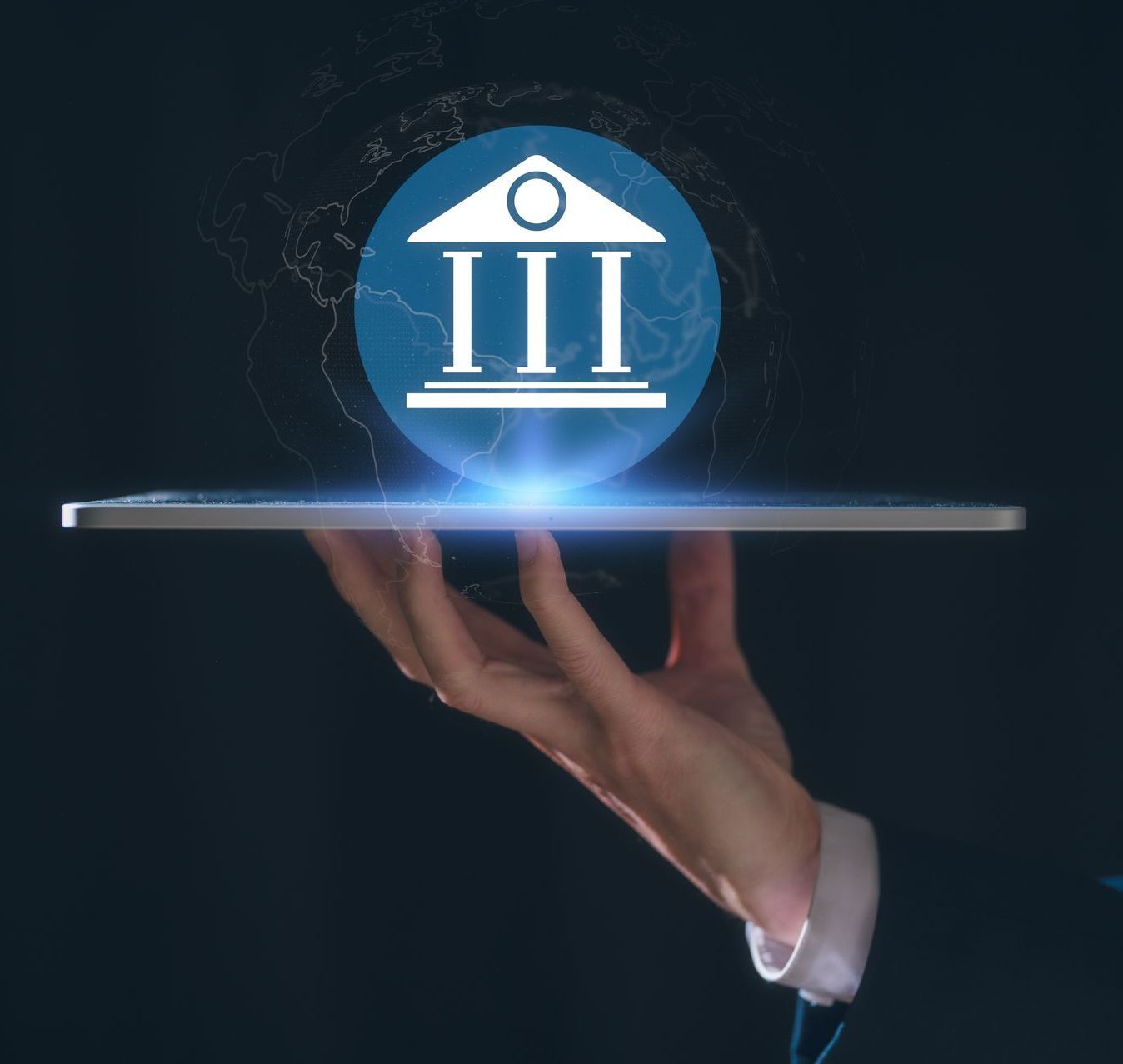 A person is holding a tablet with a bank icon on it