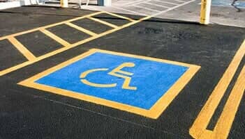 Blue and yellow empty handicap parking space - Striping in Oxford, MS