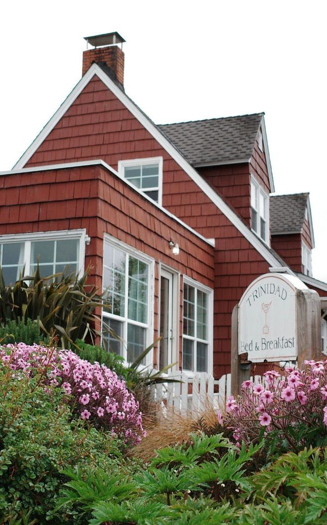 A red house with a sign that says ' open day ' on it