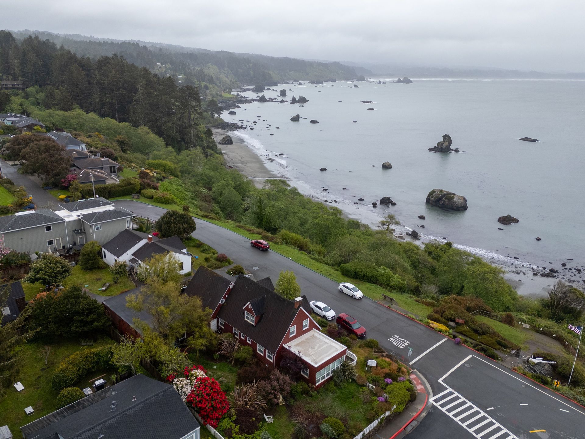 An aerial view of a residential area next to a body of water.