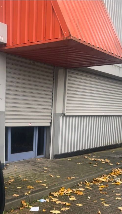 A building with a red awning on top of it.