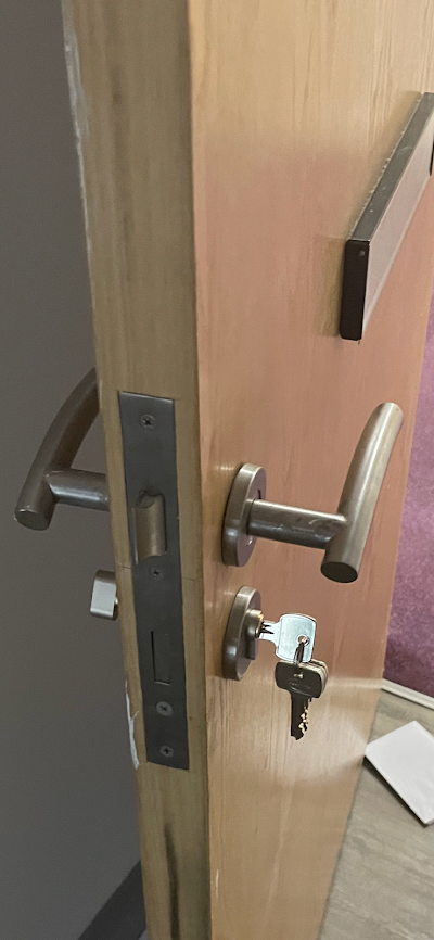 A close up of a door with a key in it.