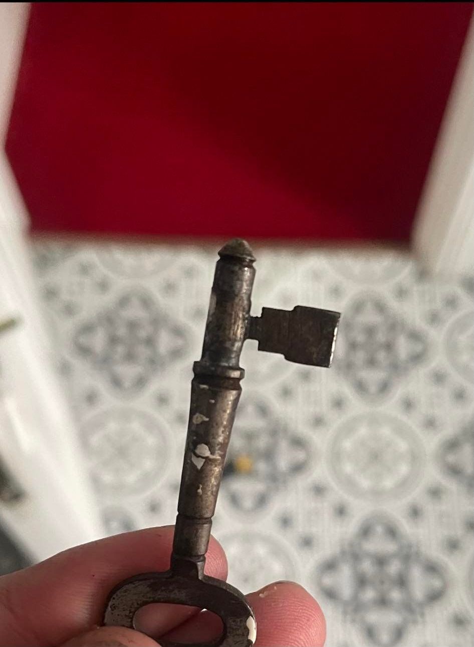 A person is holding a key in their hand.