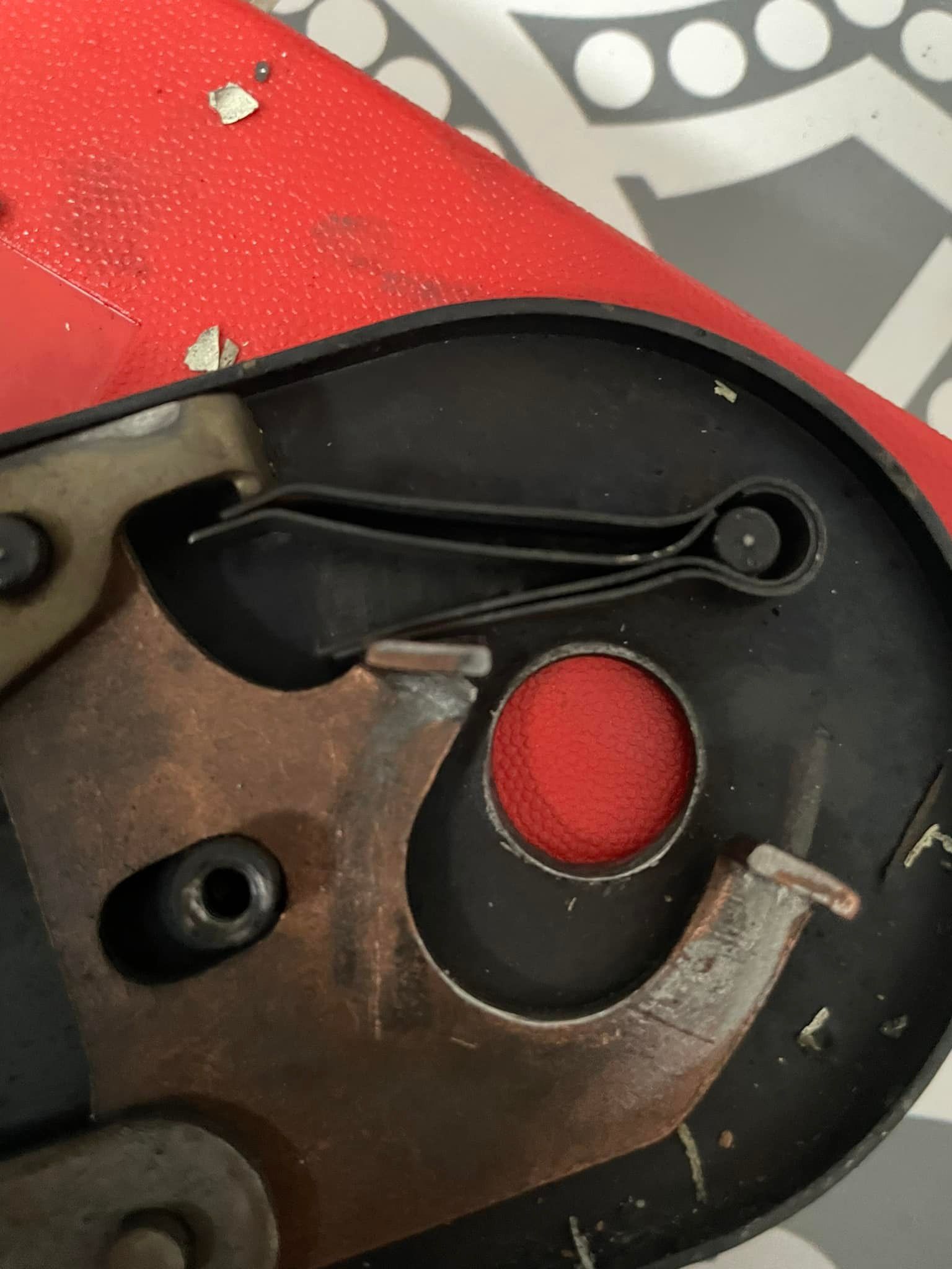 A red and black object with a red circle in the middle