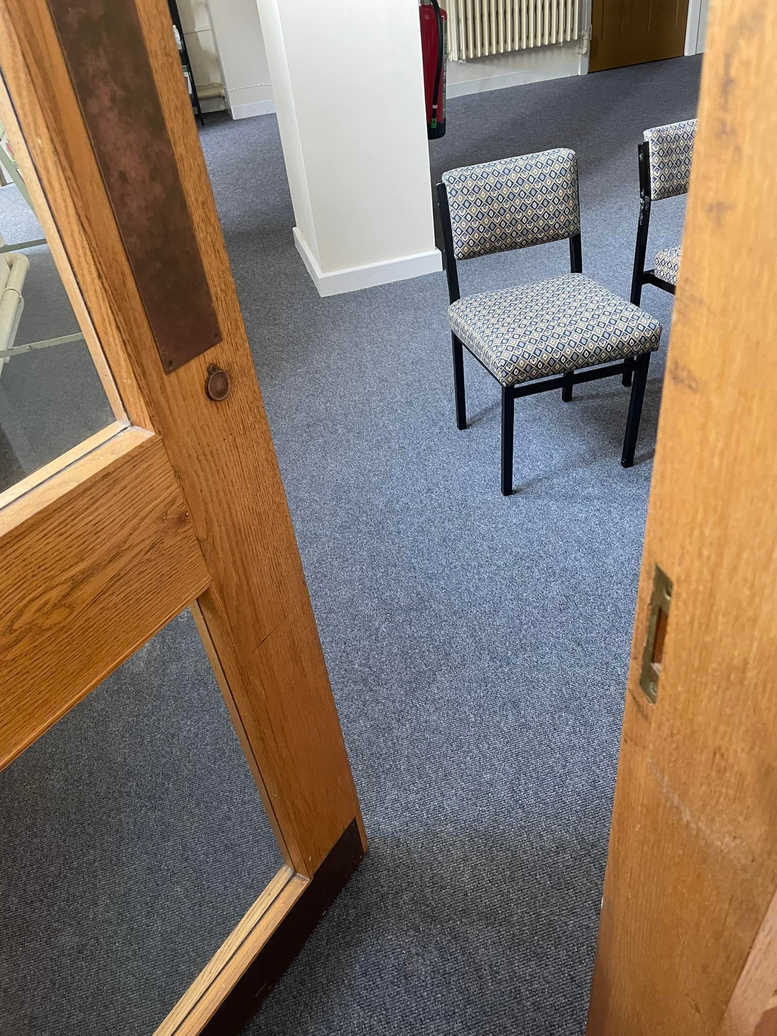 A group of chairs are sitting in a room next to a door.