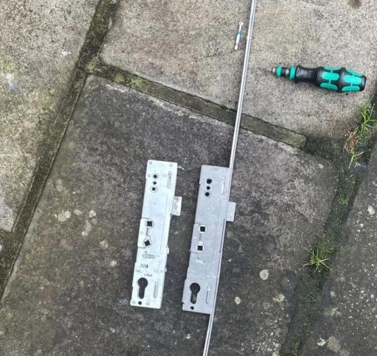 A bunch of metal pieces are laying on a white surface