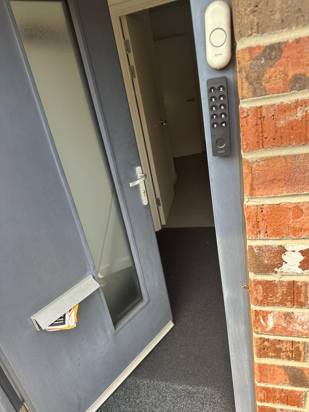 A man is fixing a door handle with a screwdriver.
