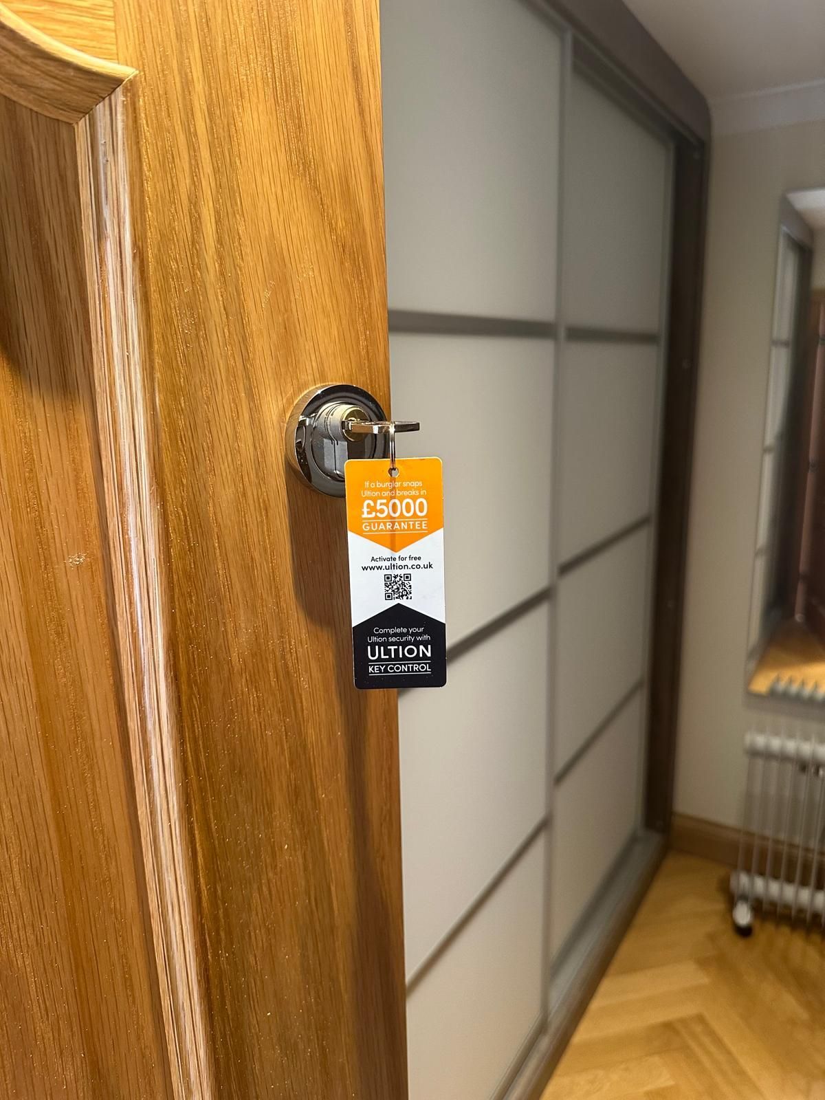 A close up of a door lock with keys in it