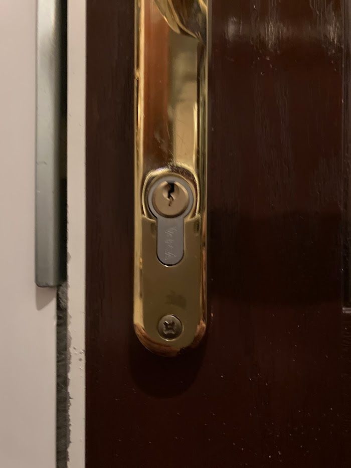 A close up of a door handle with a key in it.