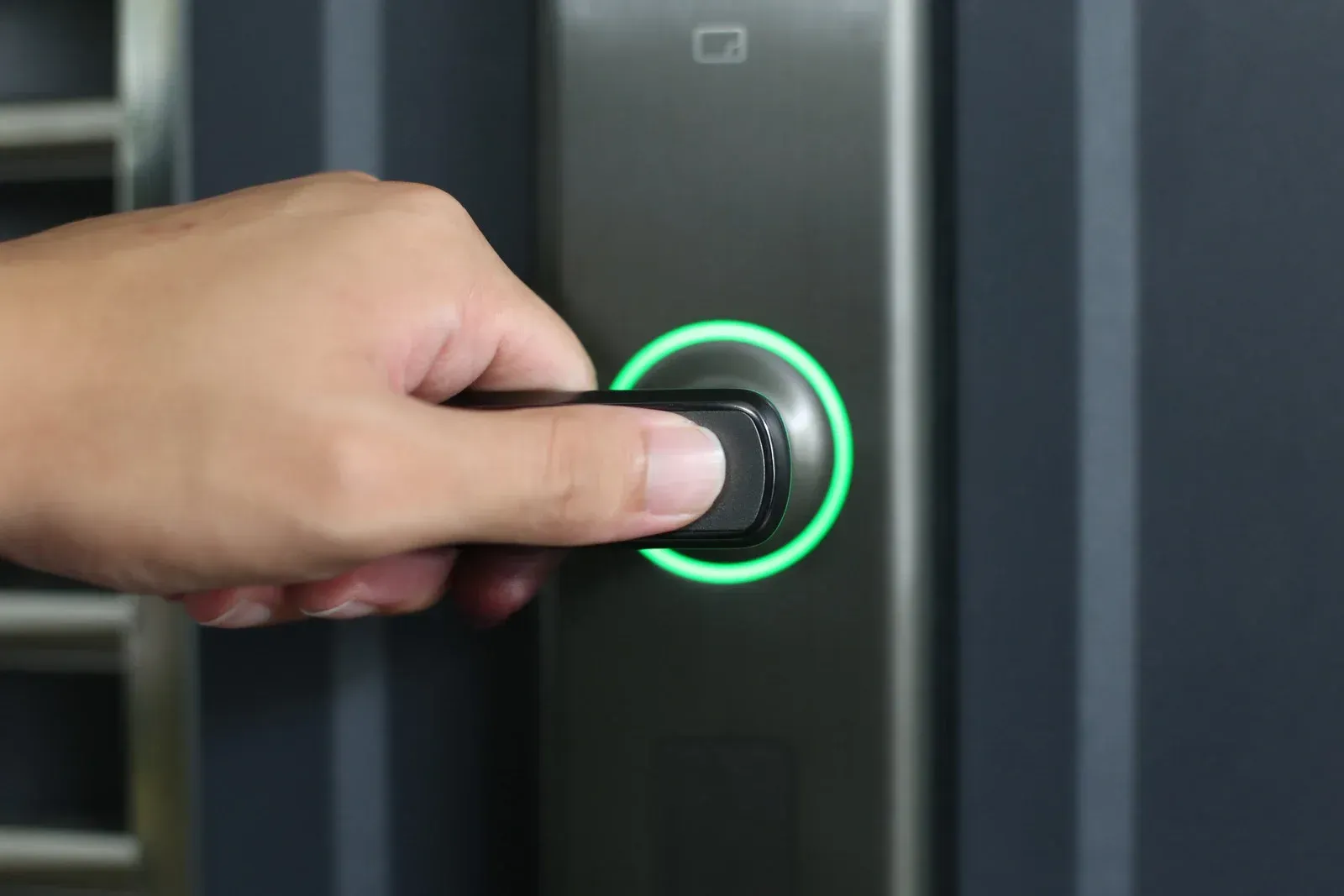 A person is using a screwdriver to open a door lock.