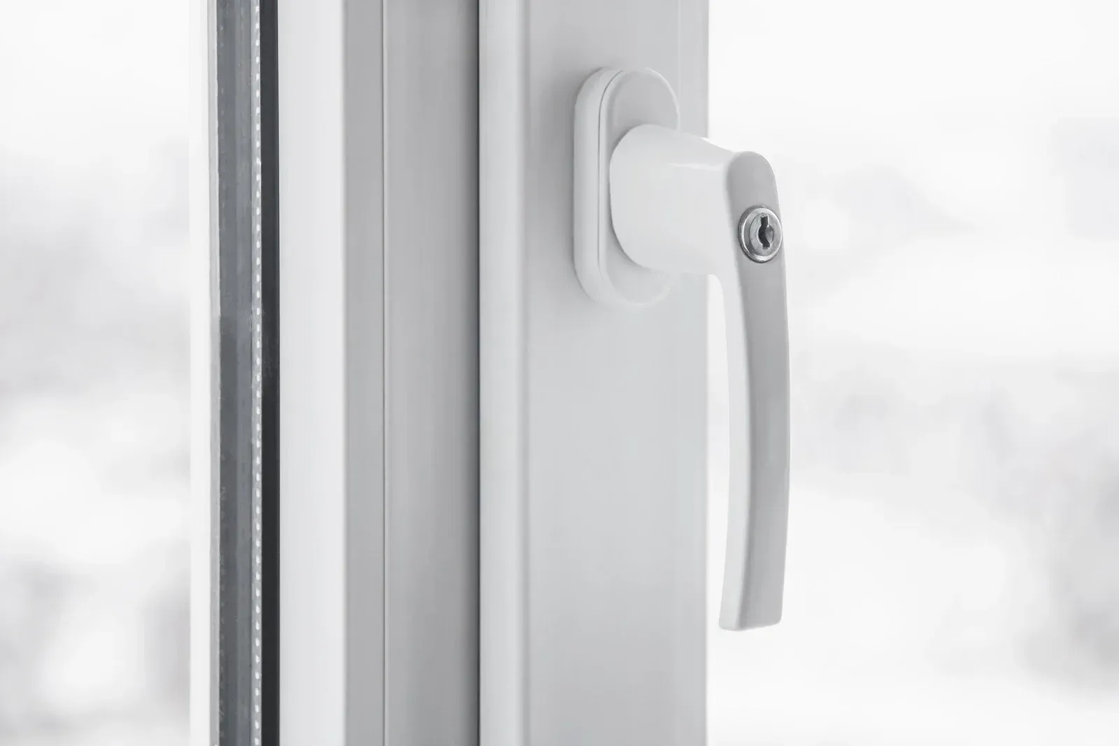 White window handle on a closed window frame