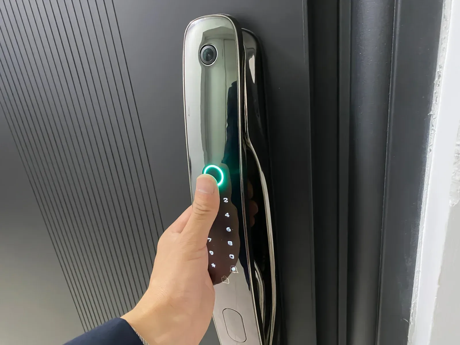 A person is using a screwdriver to open a door lock.
