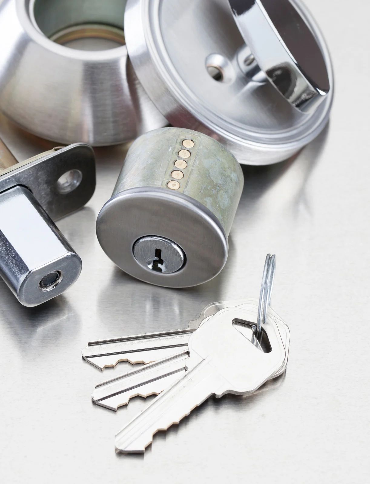 A bunch of keys and a lock on a table